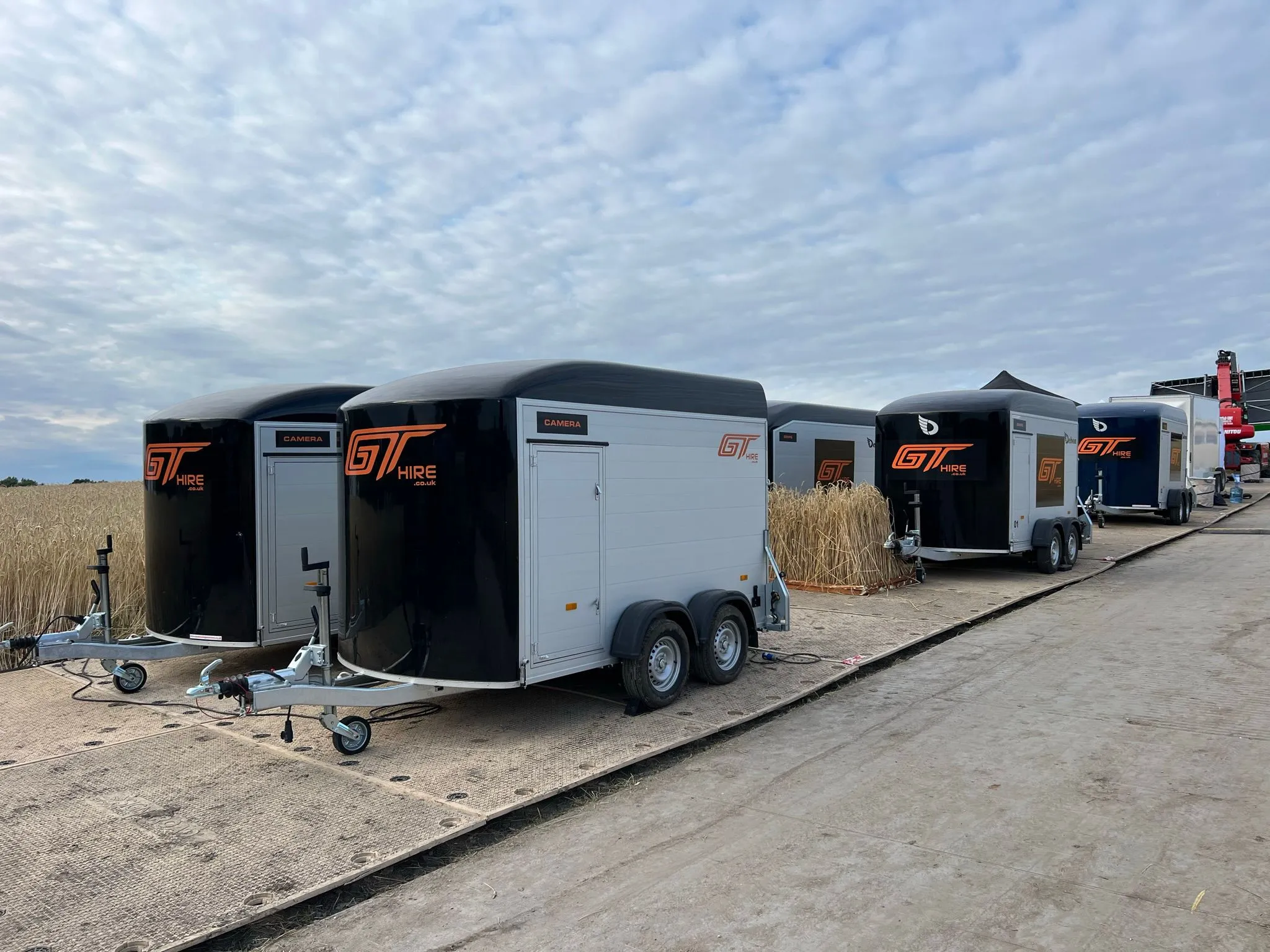 A row of trailer trailers parked on the side of a road.