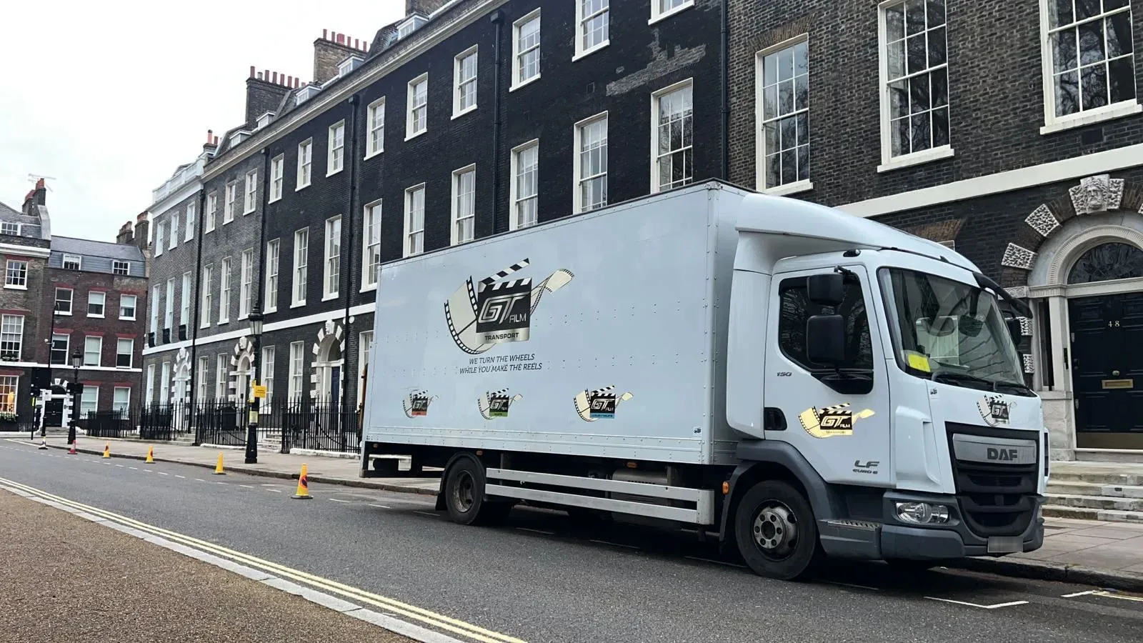 A delivery truck parked on the side of the road.