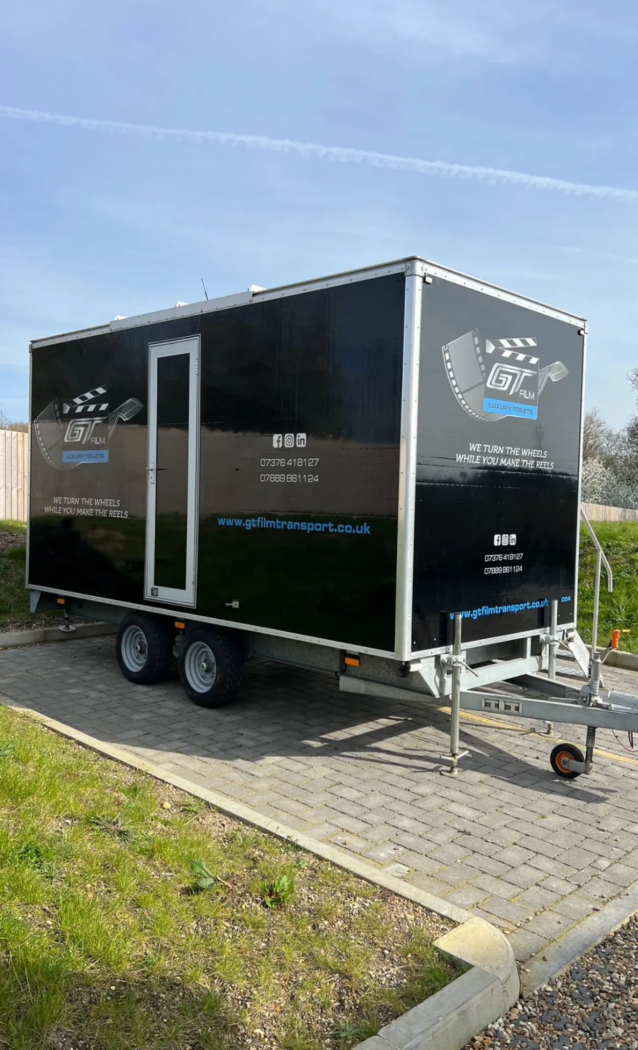 A trailer parked on the side of a road.