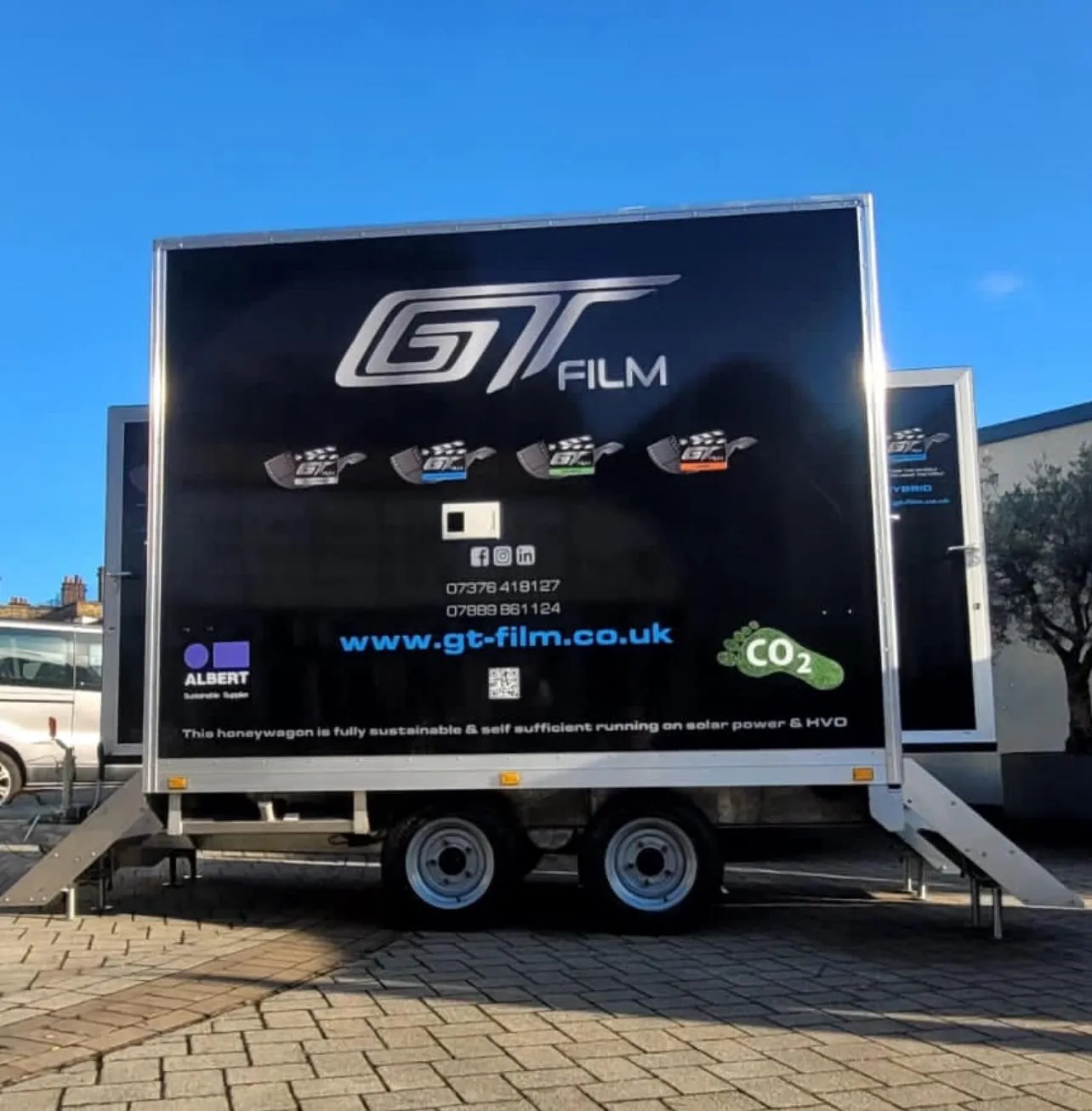 A large trailer parked on the side of a road.